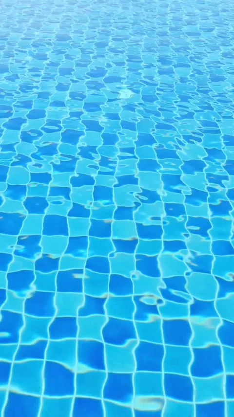 Blue Tiled Pool Water Shimmering Under Sunlight, Gentle Ripples Forming Mosaic 스톡 동영상 332645221