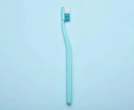 Blue toothbrush on light blue background Stock Photos