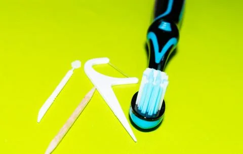 Blue toothbrush with plastic floss Stock Photos