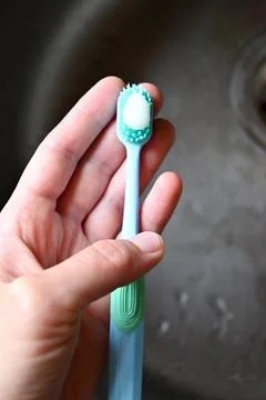 A blue toothbrush  with white toothpaste Stock Photos