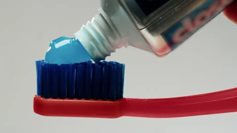 Blue toothpaste applying on brush against white background, morning, medical Stock Footage 231182524