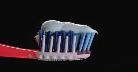 Blue toothpaste put on toothbrush macro Stock Footage 71779255
