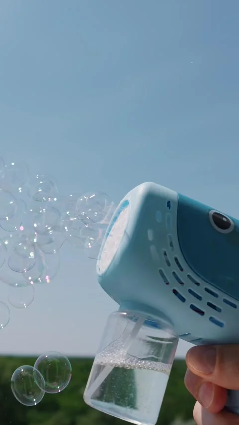 Blue Toy Bubble Blower Pointing Upwards Against Clear Blue Sky Stock Footage 339187050