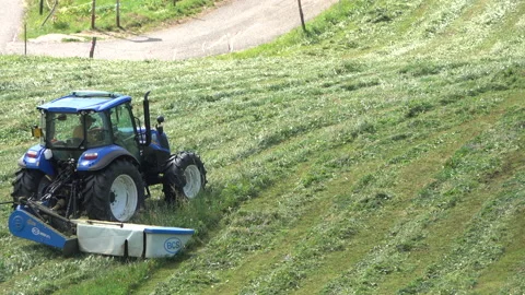 Blue tractor hay cutter Stock Footage 160119863
