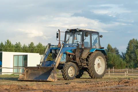 A blue tractor is leveling a construction site for the installation of modula Stock Photos