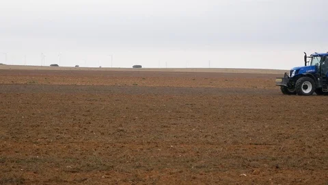 Blue tractor plows the ground Video stock 113002957