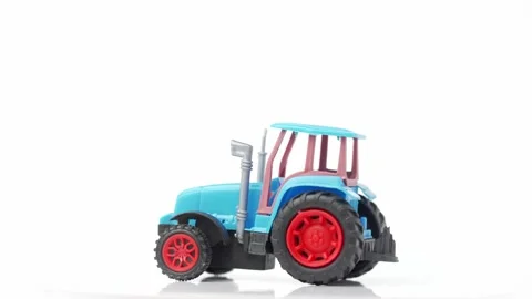 Blue tractor toy rotates on white background Stock Footage 170280313