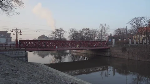 Blue train and people on the red bridge leading to Ostrow Tumski Stock Footage 108302256