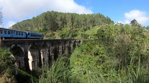 The blue train arriving on the Nine Arch Bridge in Ella, Sri Lanka Stock Footage 197055618