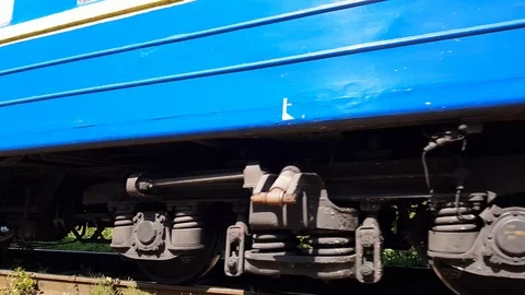 Blue train rides left at the foot of the Carpathian mountains Stock Footage 115553383