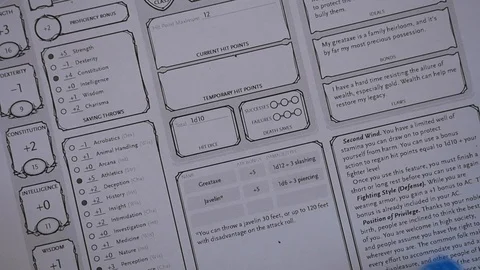 Blue transparent dice rolling onto D&amp;D character sheet Stock Footage 100310041