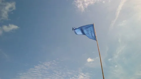 Blue triangle flag against blue sky in France Stock-Footage 135312066