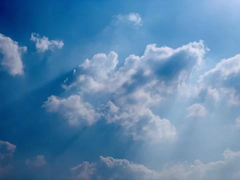 Blue Tropical Sky With Dramatic White Clouds and Sun Rays Stock Photos