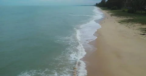 Blue turquoise ocean waves break on sand beach during storm. Stock Footage 203188631