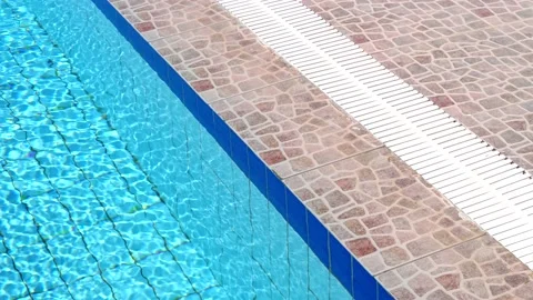 Blue turquoise pool water and a rim of pool edge close-up, diagonally. Stock Footage 132656984
