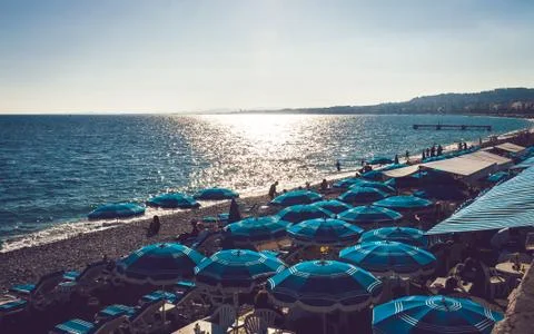 Blue umbrellas on beach in Nice Stock Photos