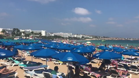 Blue Umbrellas at a Packed Beach. Overhead Zoom In Shot Stock Footage 110746532