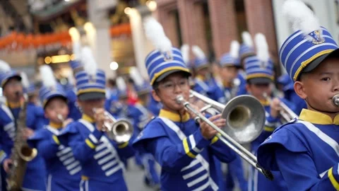 Blue Uniformed Marching Band Procession Along Urban Street Видео 345929449