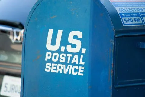 Blue U.S. Postal Service mailbox prop with collection times visible, used a.. Stock Photos