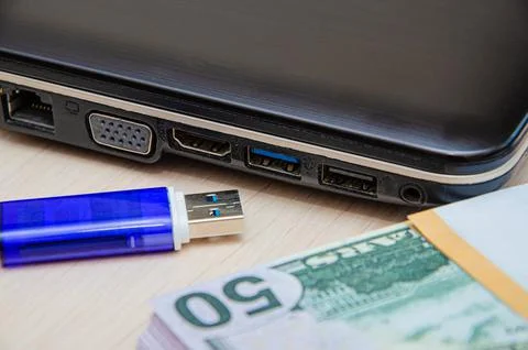 Blue USB flash drive connected to laptop computer's USB port. Notebook is on  Stock Photos