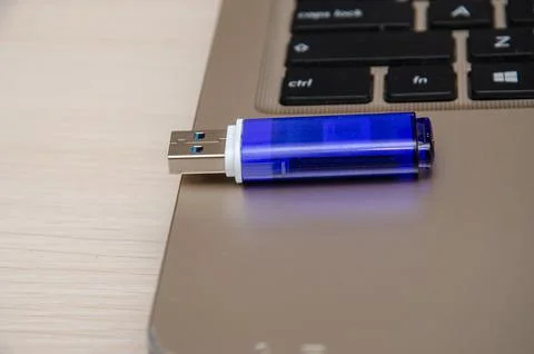 Blue USB flash drive connected to laptop computer's USB port. Notebook is on  Stock Photos