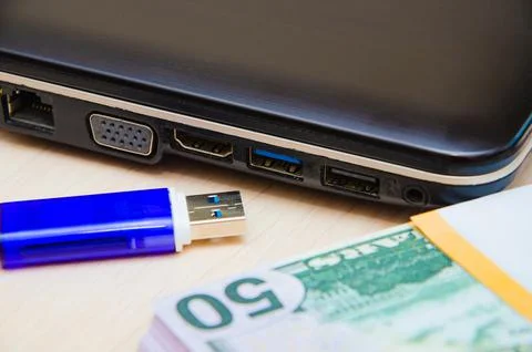 Blue USB flash drive connected to laptop computer's USB port. Notebook is on  Stock Photos