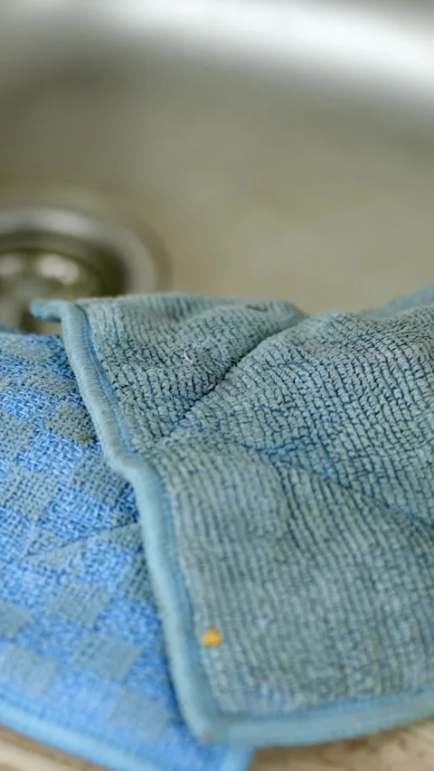 Blue used microfiber cleaning cloth lying on surface extreme macro close up Stock Footage 299980472