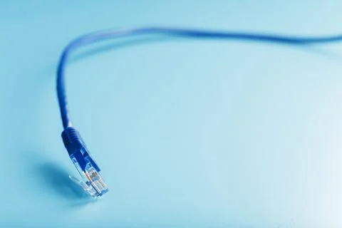 Blue UTP Internet Cable Isolated on a blue background Ethernet Cord Stock Photos
