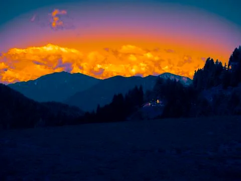 Blue valley dominated by orange clouds Foto stock