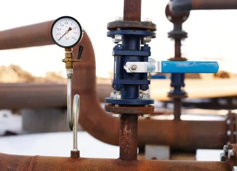Blue valve and manometer on rusty pipe Stock Photos