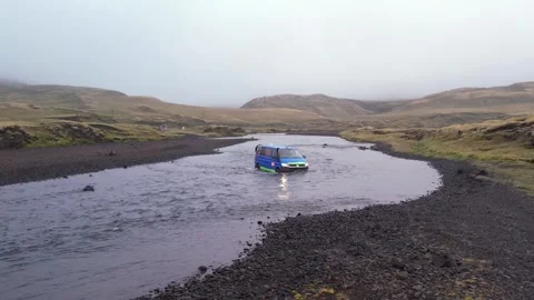 Blue Van Crosses Deep River in Iceland Epic Adventure Travel Stock Footage 258478944