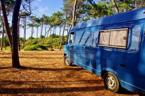 Blue van parking in the middle of forest Stock Photos