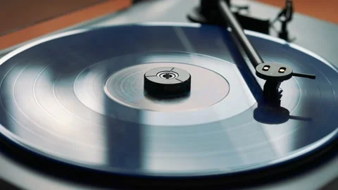 Blue vinyl record spinning and playing music on a black gramophone Stock Footage 220356789