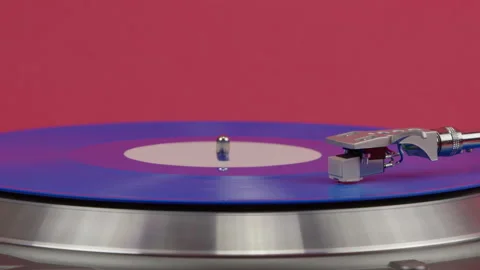 Blue vinyl record spinning on turntable isolated on red. LP player in motion Video stock 154331370