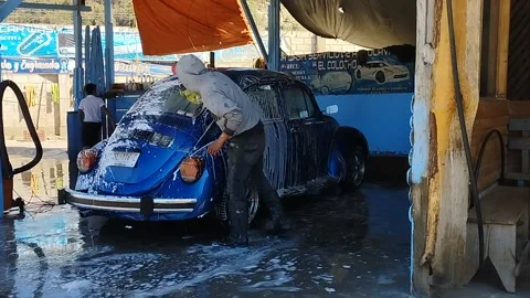 Blue VW beetle Vocho hand car wash in Mexico Stock Footage 234977116