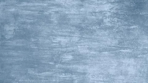 A blue wall with a brush stroke pattern. The wall is painted in a light blue  Stock Photos