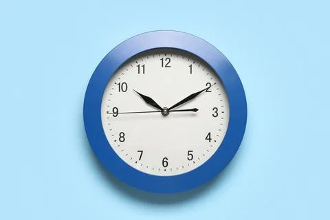 Blue wall clock showing time at 10:10 Stock Photos