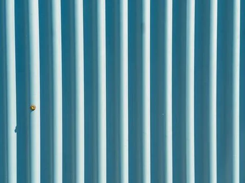 A blue wall features vertical lines with a small detail that stands out near  스톡 사진