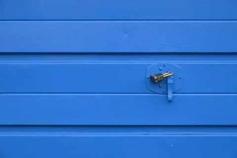 A blue wall with a lock on it Stock Photos