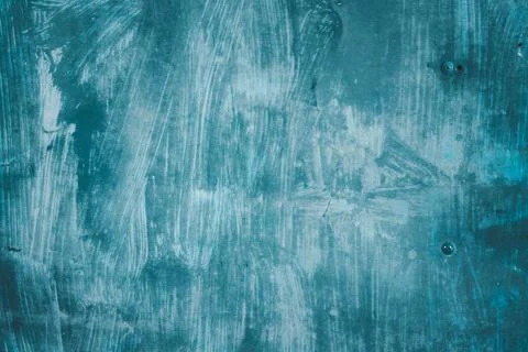 A blue wall with a lot of paint splatters and brush strokes Stock Photos