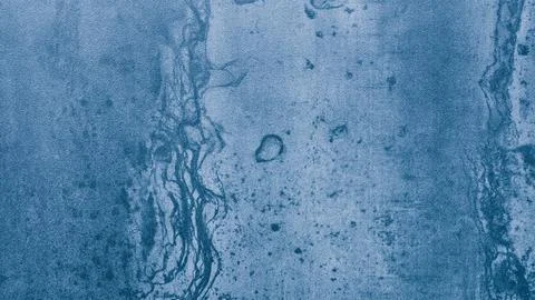 A blue wall with a pattern of dots and lines. The wall is made of concrete Stock Photos