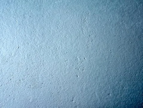 Blue wall with a rough texture Stock Photos