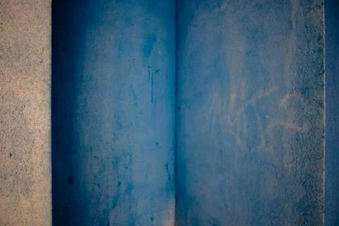 Blue walls full of spots, graphitty letters and other dirt pieces in Pamplona Stock Photos