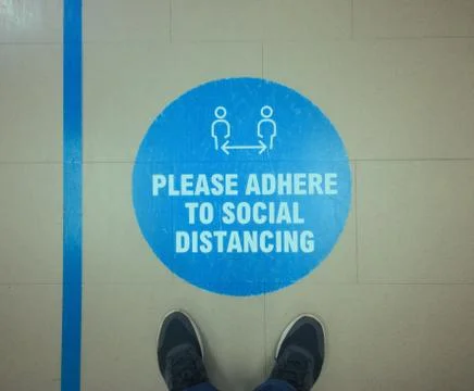 Blue warning sign to maintain keep social distance Stock Photos