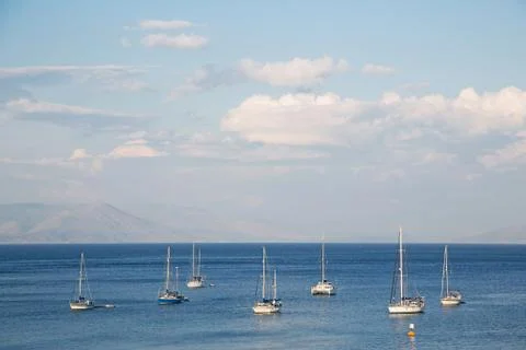 Blue water and sky background on the ocean with sailing boats. Stock Photos
