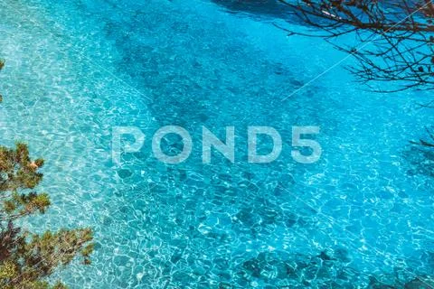 Blue water background. Turquoise ripple water with sun reflections Stock Photos