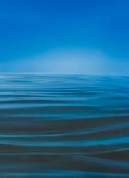 Blue water background with waves Stock Photos