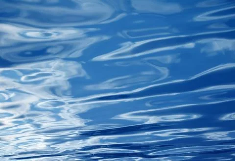 Blue water background with waves Stock Photos