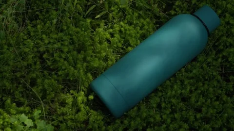 Blue Water Bottle on Mossy Forest Ground Stock Footage 289084147