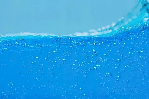 Blue water with bubbles and waves in a swimming pool 스톡 사진